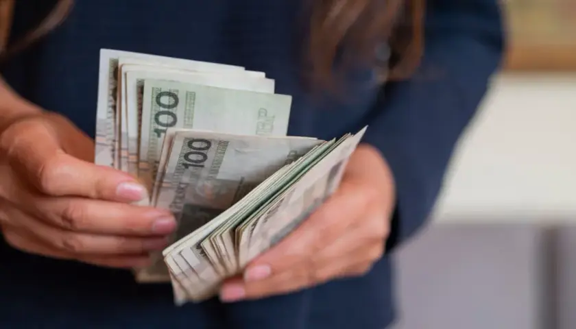 Ręce liczą banknoty 100 zł. To miła darowizna od siostry na nowy projekt.